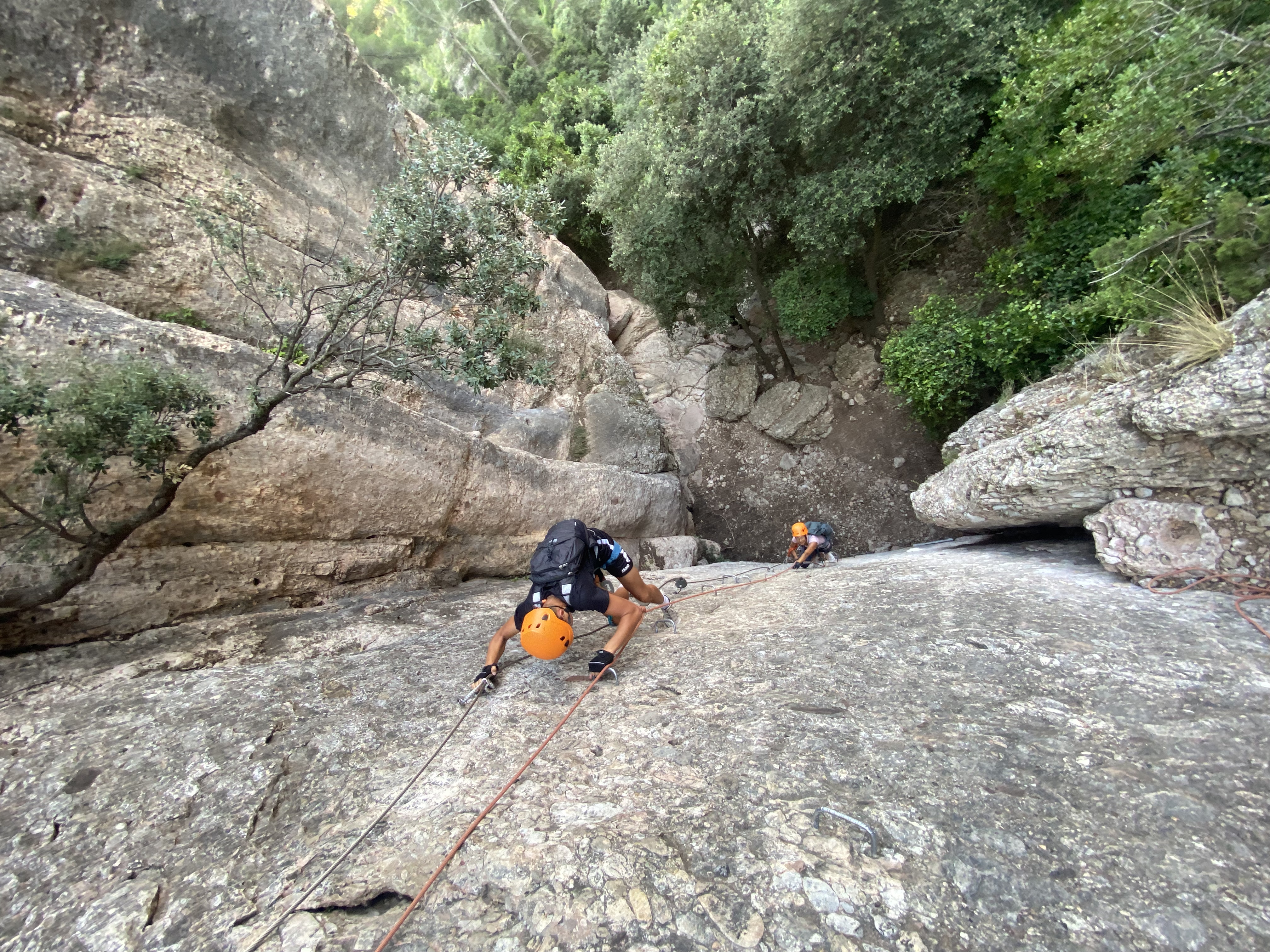 Climbing a guided via ferrata cable route in Catalunya