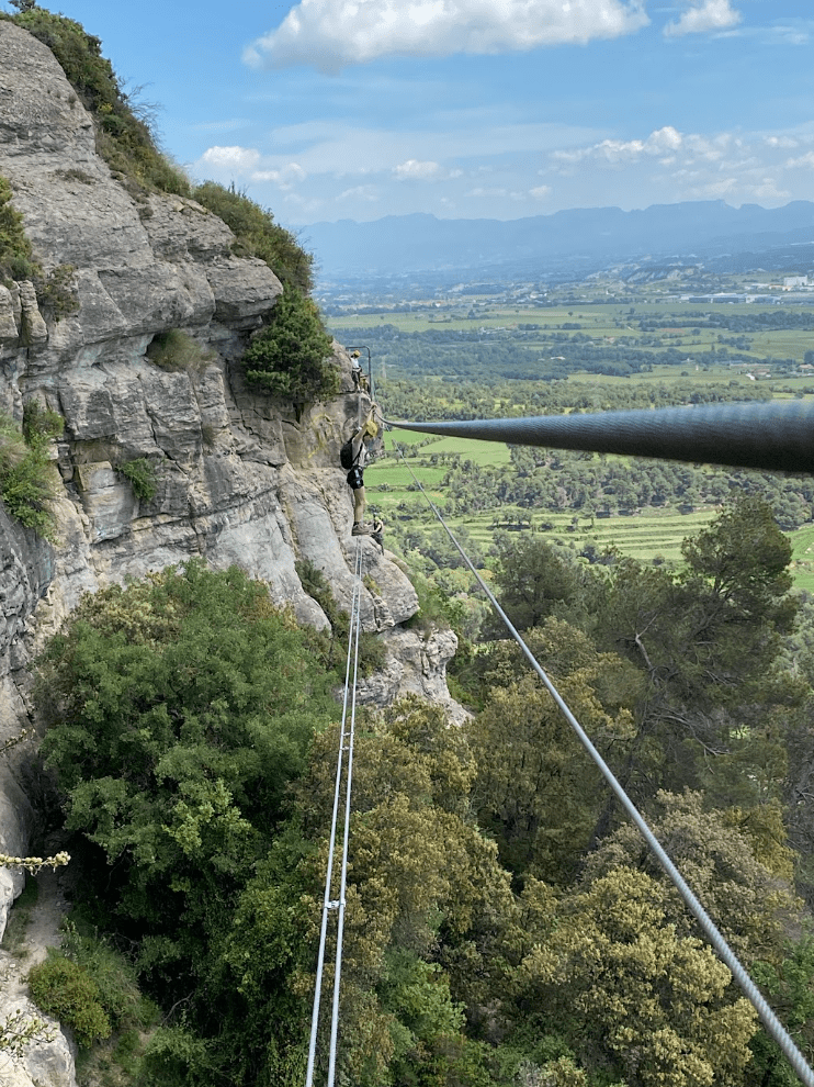 Crossing the Nepalese bridge on the Baumes Corcades via ferrata in Centelles
