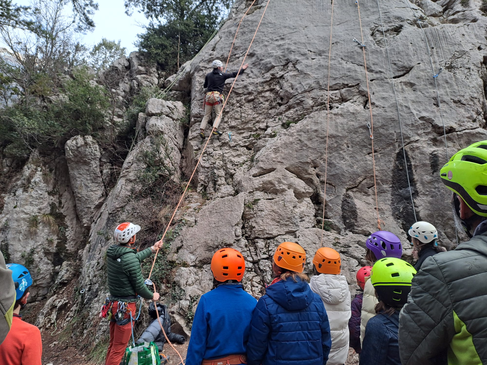A child top-roping on real rock with a mountain guide near Barcelona