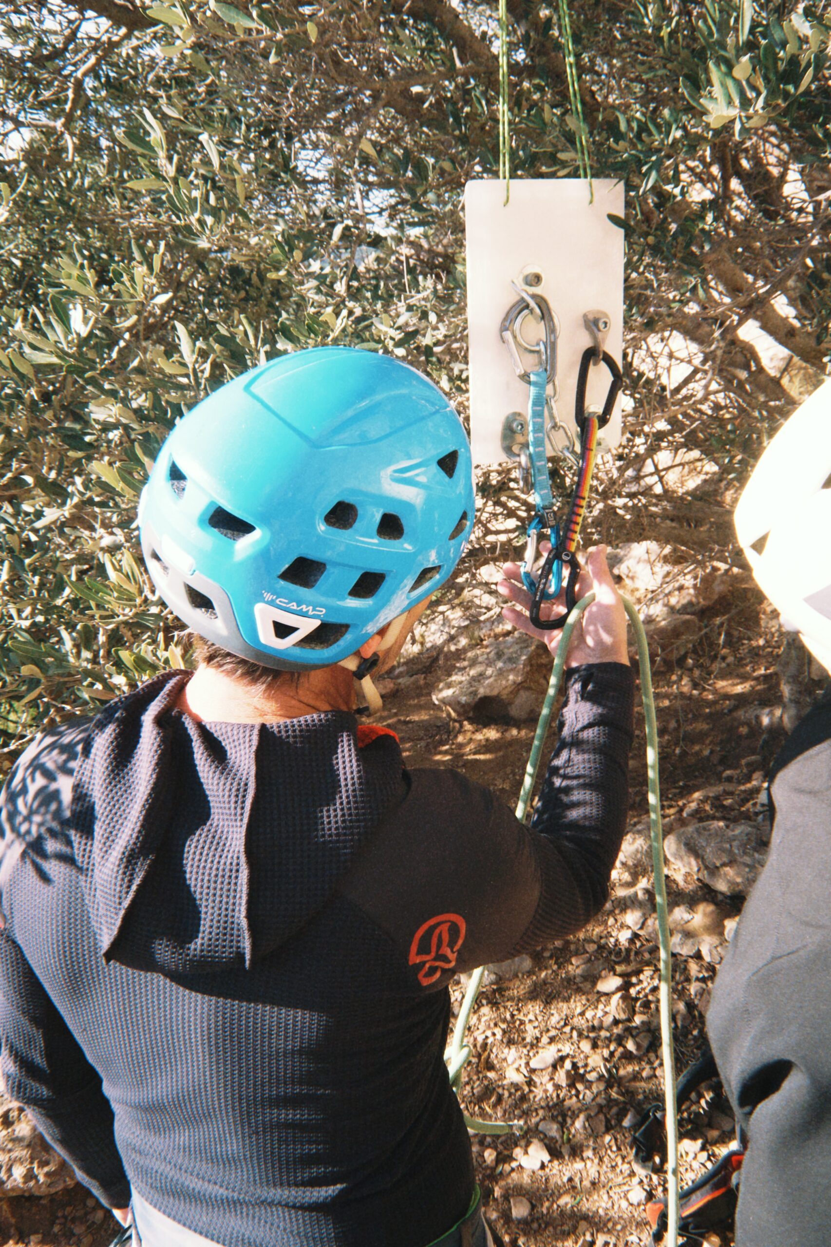 A beginner learning to tie in on real rock near Barcelona with a mountain guide