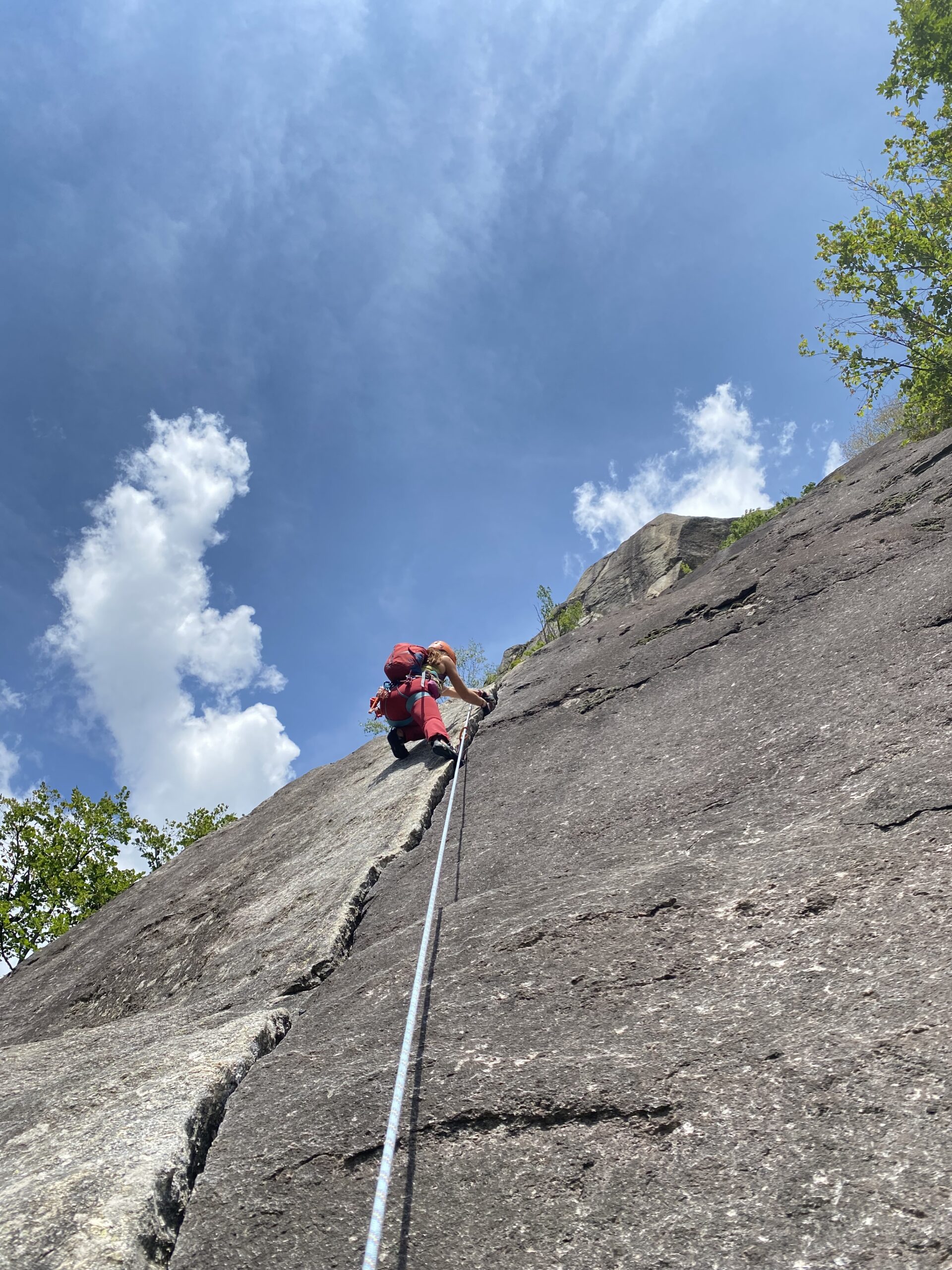 Placing a cam in a crack during a trad climbing course in Catalunya