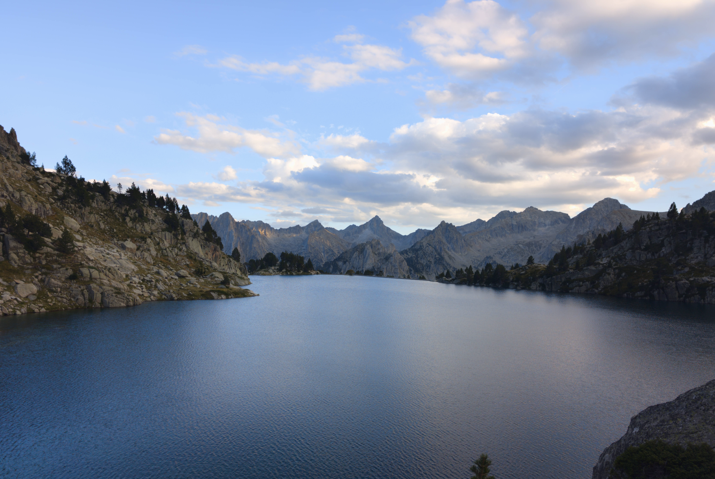 Mountain refuge beside a lake among granite peaks in Aigüestortes National Park